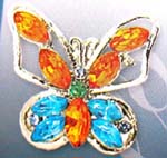 Ladies brooch wear accessory distribution manufacturer. Silver plated butterfly pin with cz gems in wings and in body along with an emerald green rhinestone in center