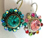 Wholesale gem stone jewelry distributor. Floral motif stud style earrings with large colored cz gem in center