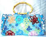 Summer style wholesale tote bag accessory store. Sequin fashion handbag with colorful flower design atop light blue fabric